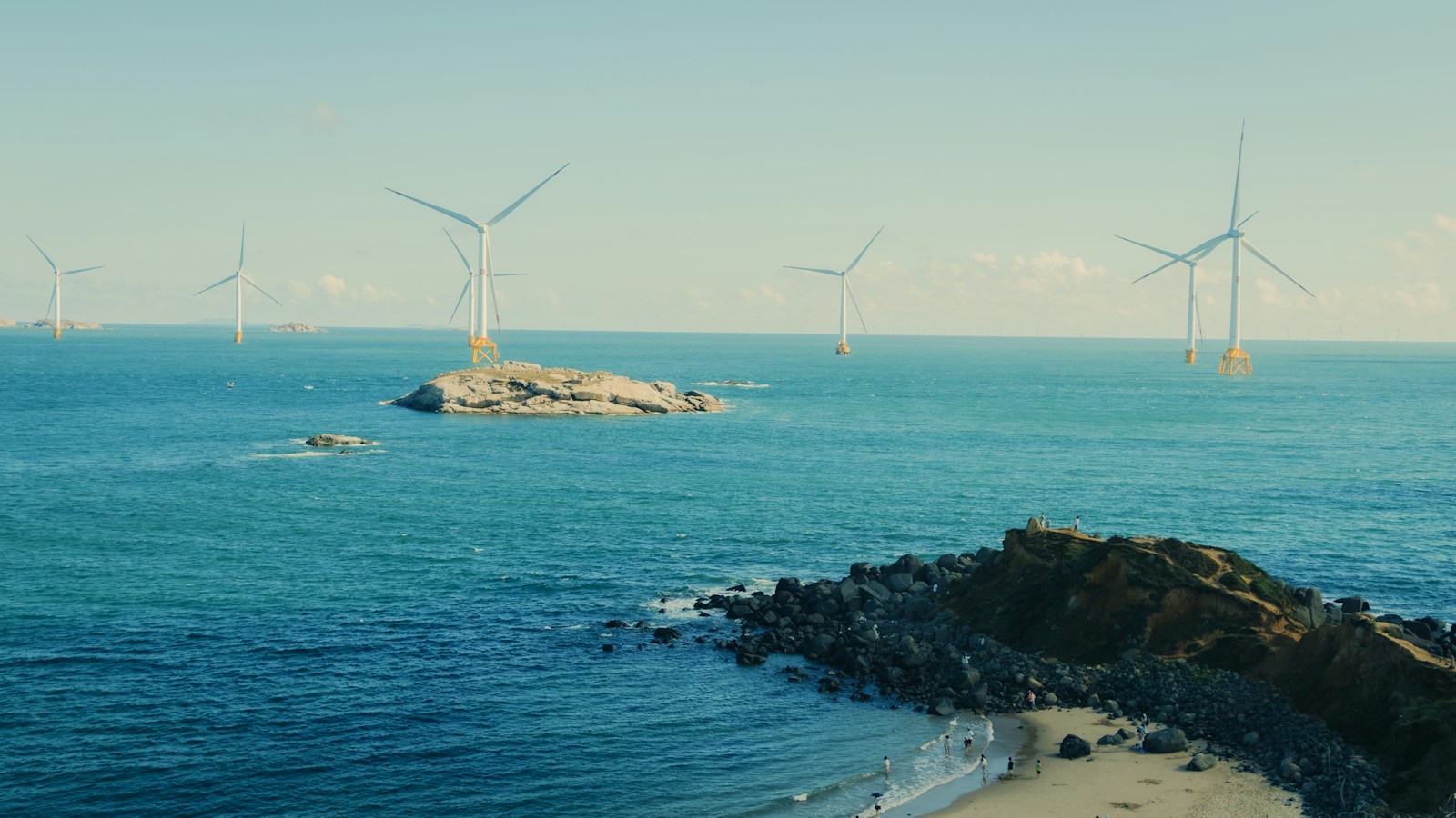 Wind turbines operating off a rocky coastline